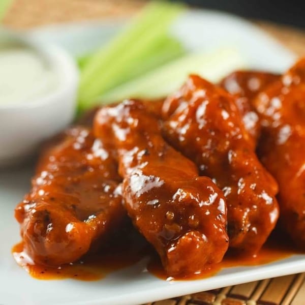 Soprano's Pizza and Pasta's buffalo wings, coated in rich red sauce, served with celery and ranch.